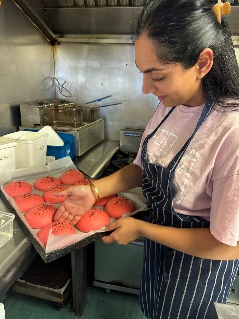 Radhika with a tray of freshly baked buns