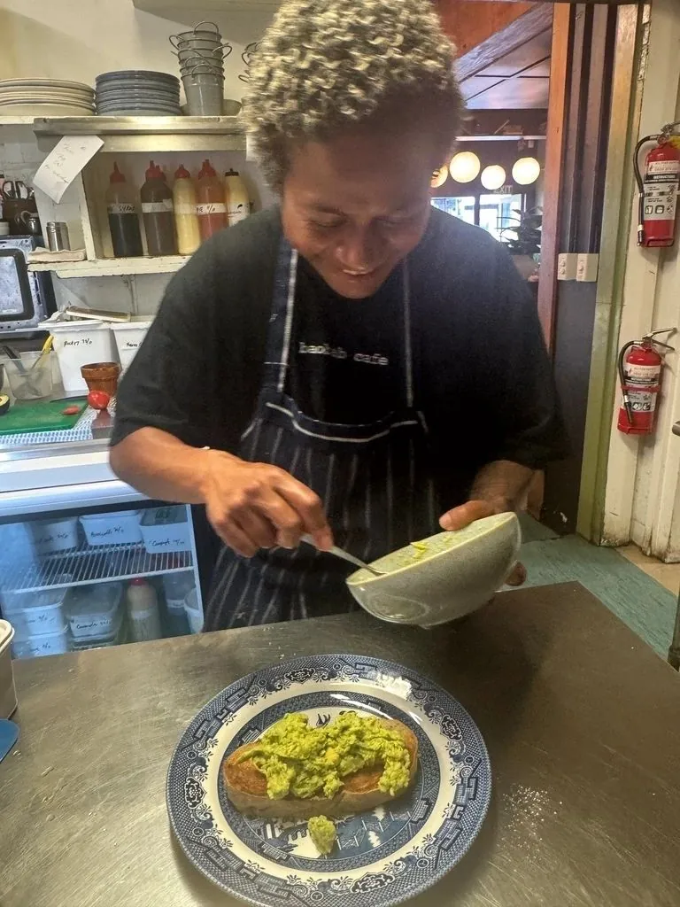 Chef plating avocado toast in the Baobab kitchen